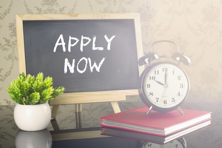 Apply Now on blackboard with clock and flare